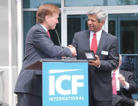 Gov. Bob McDonnell (left) presents a gift to ICF International Chairman and Chief Executive Officer Sudhakar Kesavan during Monday's grand opening ceremony at the company's Martinsville facility.